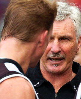 Nathan Buckley talks with his coach Mick Malthouse during the round two match between Collingwood and the Western Bulldogs at the MCG in 2004.