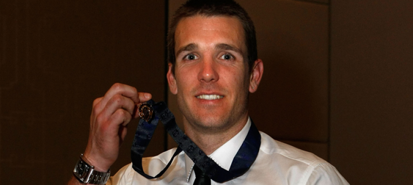 Dane Swan proudly displays his Brownlow Medal, won in 2011.