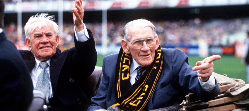 Old enemies become friends: Lou Richards and Jack Dyer enjoy a lap of the MCG in 1999.