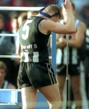 Nathan Buckley takes off the Norm Smith Medal after the 2002 Grand Final loss to Brisbane.