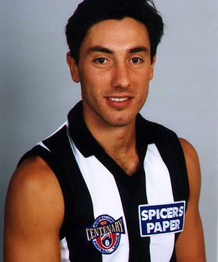 Andrew Tranquilli's head shot in 1996, the guernsey displays the AFL logo celebrating 100 years since the creation