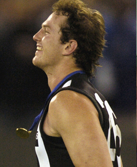 Ben Johnson runs off the ground after receiving the Jason McCartney Medal in 2004.
