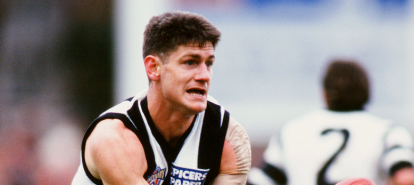 Gavin Crosisca gets a handpass away during the 1996 round 16 AFL match between Collingwood and Fitzroy.